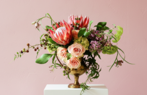 King proteas with roses, lilac, and other blooms