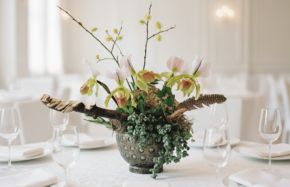 Lady slipper orchids with mossy branches and pussy willow in low bowl